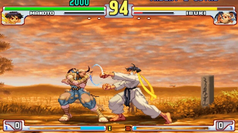 Ibuki és Makoto harcol egymással egy földúton 