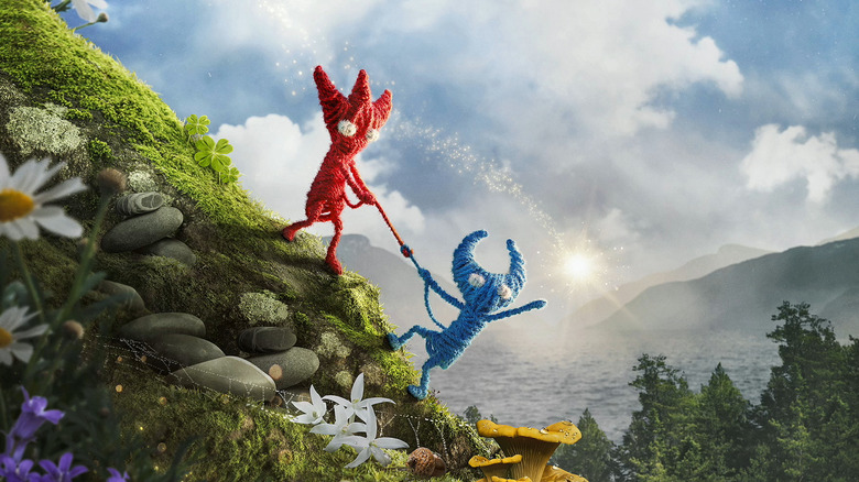 Egy piros Yarny felsegíti a kék Yarny-t a dombra, miközben a fényért nyúlnak az Unravel Two borítóján