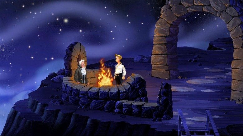 Guybrush Threepwood egy sziklán lévő tábortűz mellett beszél egy férfival a Majomsziget titka című filmben
