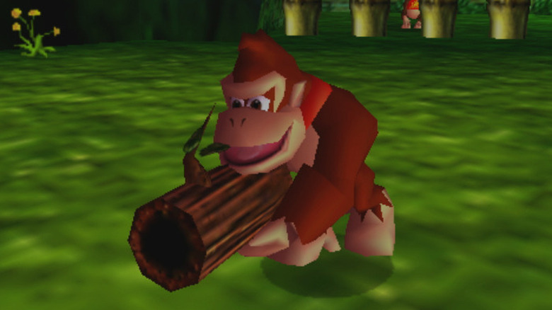 Donkey Kong egy nagy fából készült fegyvert tart a kezében 