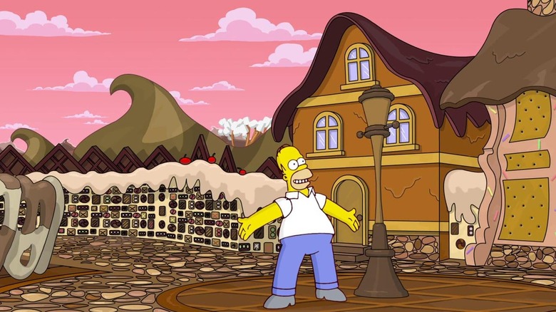 Homer Simpson diadalmasan áll a csokoládéból készült városban a The Simpsons Game-ben