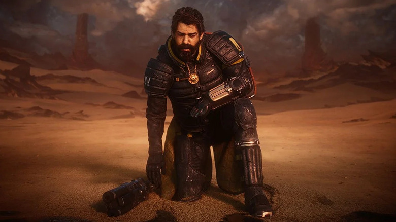 Arjun Devraj egy sivatagban térdel Sárosban