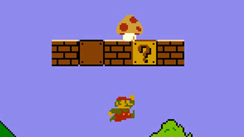 Mario ráugrik egy kérdőjelre, miközben egy gomba ül fölötte a Super Mario Bros-ban.