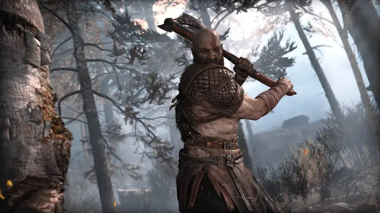 Kratos arra készül, hogy fejszével fát vágjon a God of War-ban (2018)