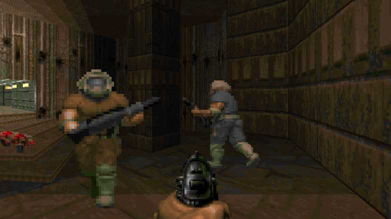A játékos egy pisztolyt mutat két űrhajósra a Doomban (1993)