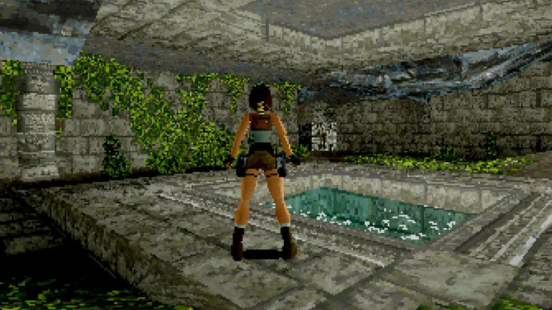 Lara Croft egy víztó közelében áll a Tomb Raiderben (1996)