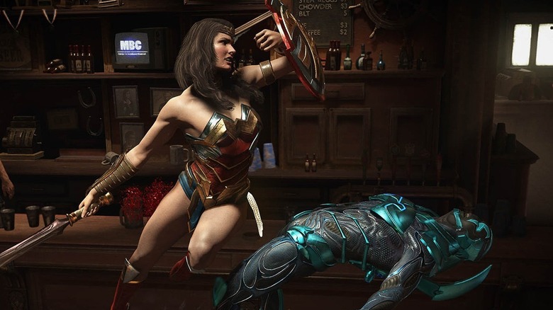 Wonder Woman megüti Blue Beetle-t a pajzsával az Injustice 2-ben