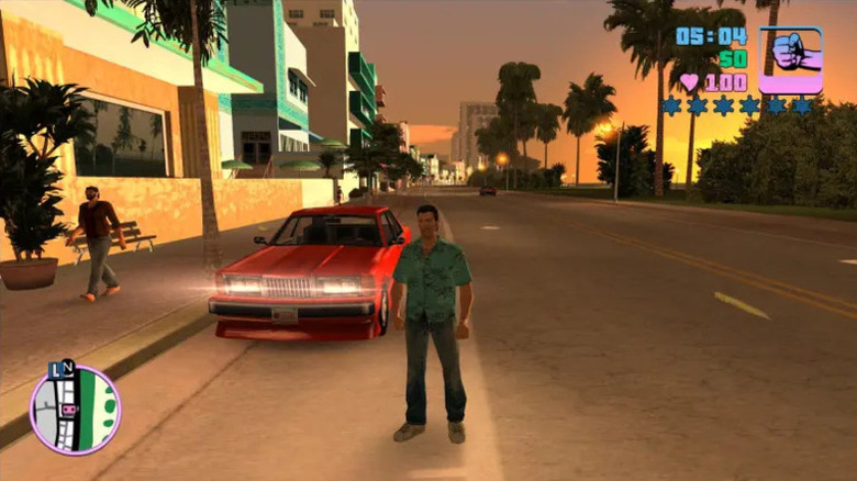 Tommy Vercetti egy piros autó mellett áll az utcán a Grand Theft Auto: Vice Cityben