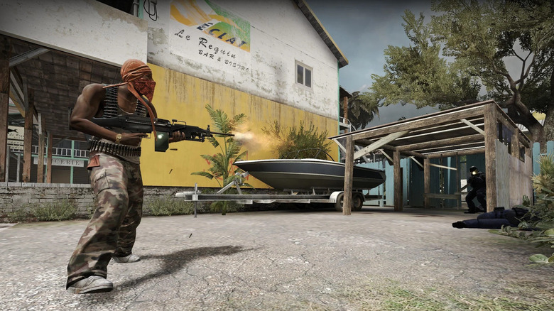 Egy terrorista gépfegyverrel lő a terrorelhárítókra a Counter-Strike: Global Offensive játékban
