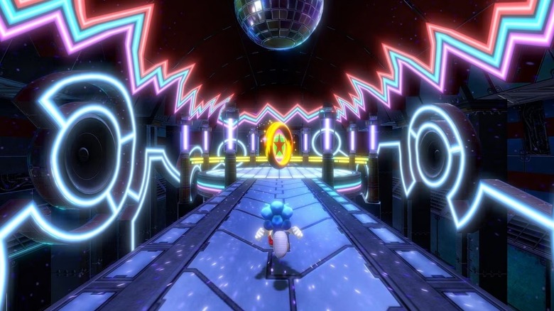 A Sonic egy nagy aranygyűrű felé fut egy diszkólabda alatt a Sonic Colors színben