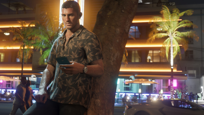 Jason egy fának dőlve tartja a telefont a GTA 6-ban
