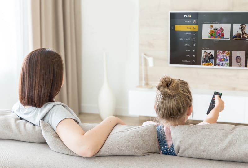 Plex app interface displayed on a smart TV screen in a living room