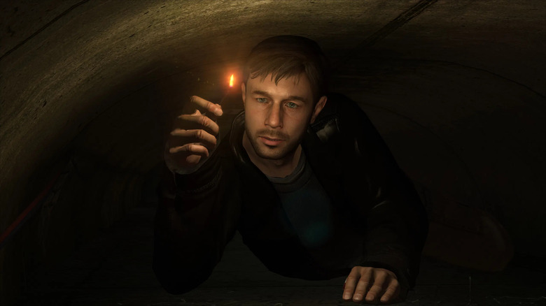 Ethan Mars égő gyufával kúszik át egy alagúton Heavy Rainben