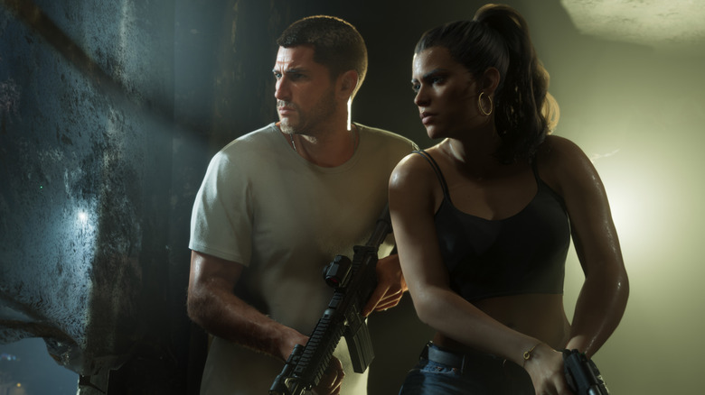 Jason és Lucia fegyvert tartva néz ki az ablakon a Grand Theft Auto 6-ban