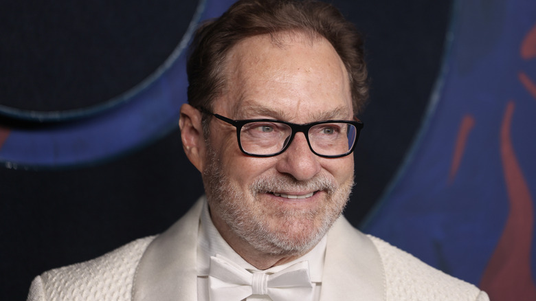 Stephen Root színész, fehér öltönyben, mosolyogva