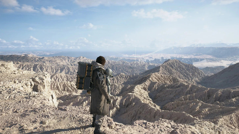 Sam Bridges a Death Stranding 2: On the Beach-ben Lou-t cipelve egy hegyláncot mér fel