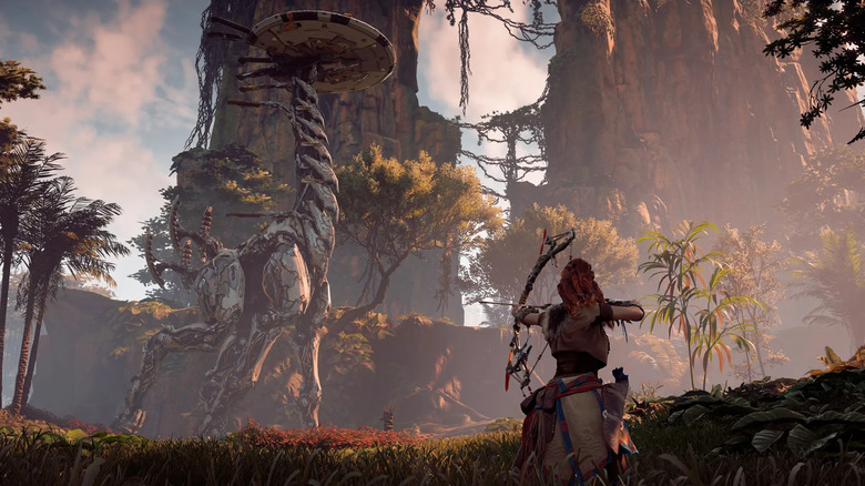 Aloy egy nyilat céloz egy nagy sétálógépre a Horizon Zero Dawnban