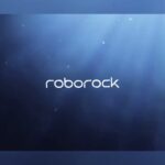 Roborock RockAqua P1 robotic pool cleaner floating at the waterline of a swimming pool