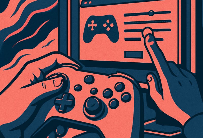 A gaming controller sitting next to a PC keyboard with a game settings menu visible on the monitor