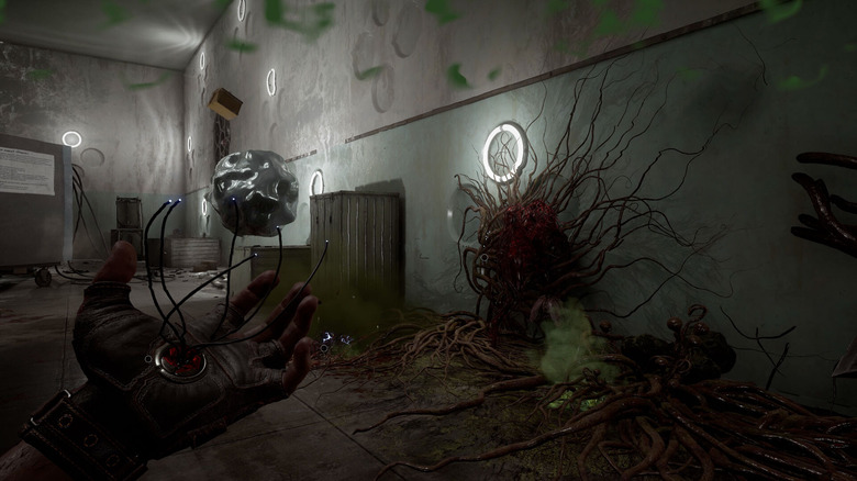 Egy Atomic Heart játékos egy falat néz, amelyen egy furcsa növény nő
