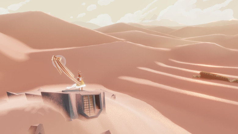 A játékos karakter végigméri a sivatagot, miközben egy zászló lobog mellettük a Journey (2012) című filmben.