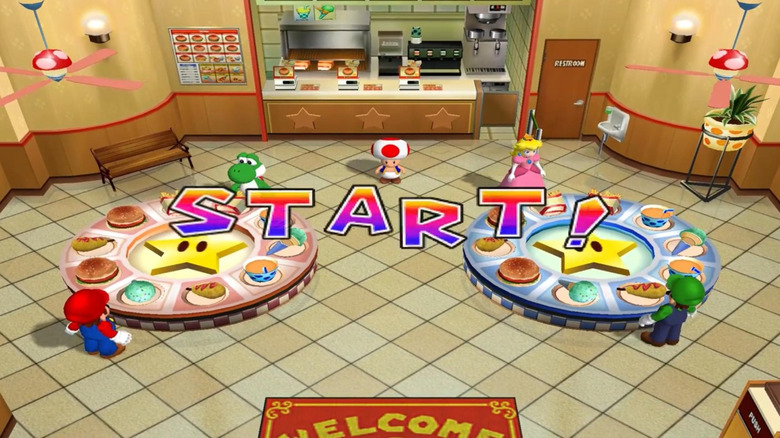 Mario, Yoshi, Peach és Luigi az ételekkel teli asztalok mellett állnak a Mario Party 4-ben
