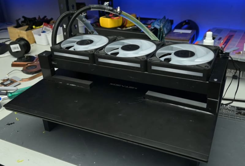 Laptop AIO radiator mod showing external tubing and fans attached to a gaming laptop chassis