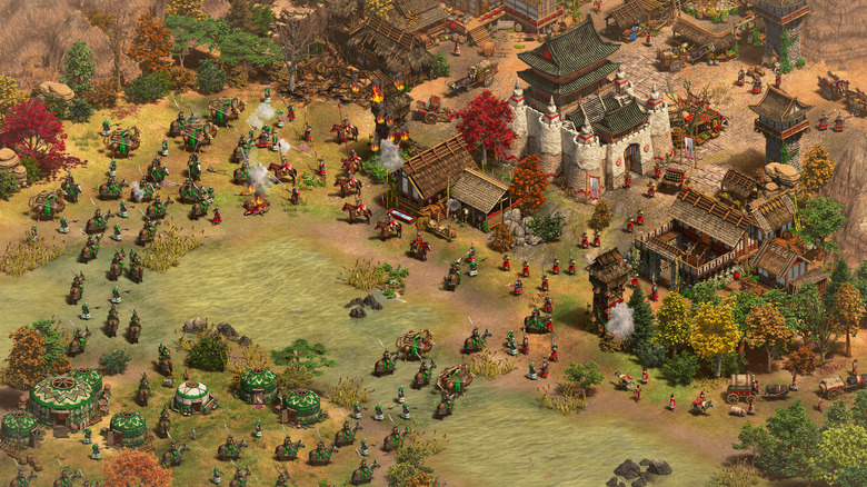 Egy hadsereg megtámad egy települést az erdőben az Age of Empires II-ben