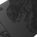 Fujitsu Godzilla laptop lid showing a black Godzilla illustration and dorsal fin shaped touchpad