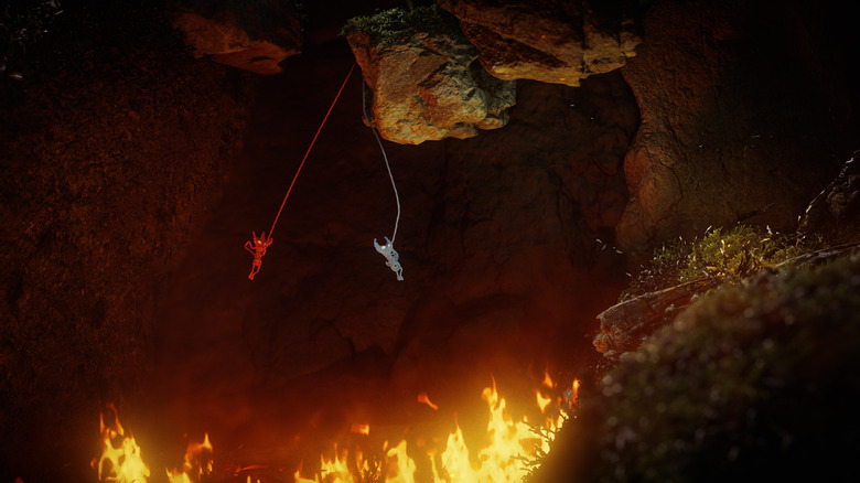 Az Unravel Two két szereplője egy tűzrésen átlendül