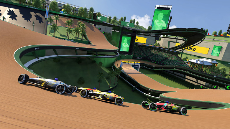 Három versenyző a Trackmaniában száguldozik egy pálya körül
