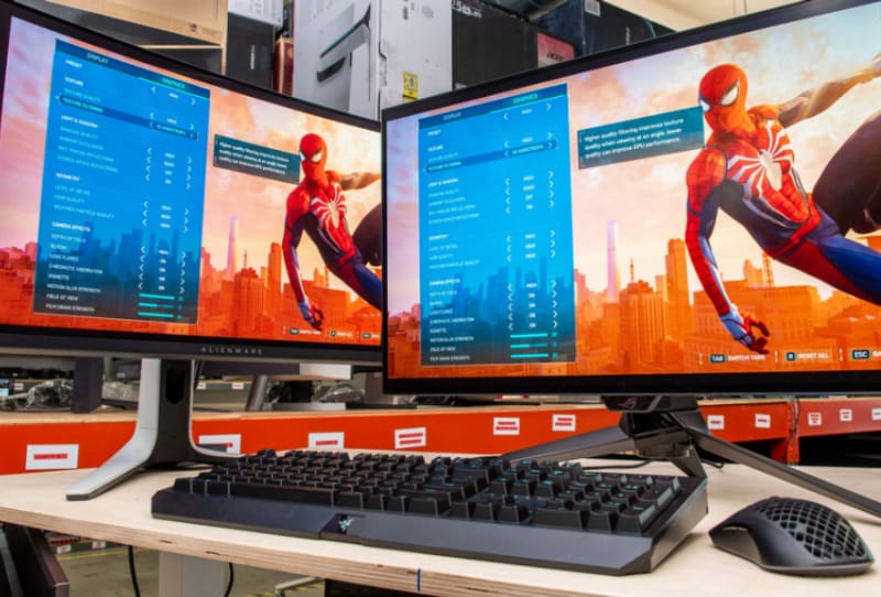 A competitive FPS gamer sitting in front of a high refresh rate gaming monitor