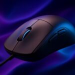 Hand gripping a gaming mouse in claw grip position with fingers arched over the buttons