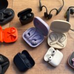 A runner wearing wireless earbuds with an earhook design while jogging outdoors